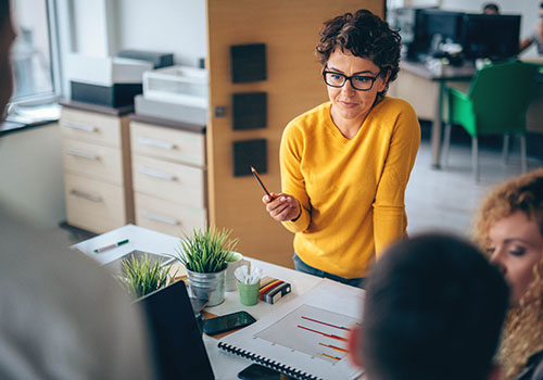 A group of professionals sit around a table at a DiscoverFAD course for professionals