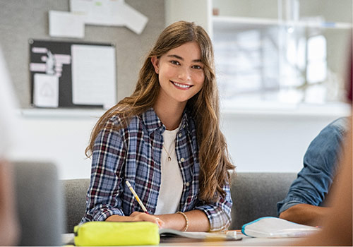 A high school student studying a DiscoverFAD short course smiles at the camera.