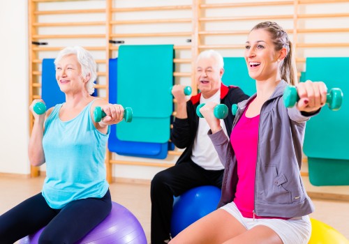 Two women on exercise balls using free wrights in a session at the Cancer Wellness Centre in UC Health Clinics Specialist Medical Centre