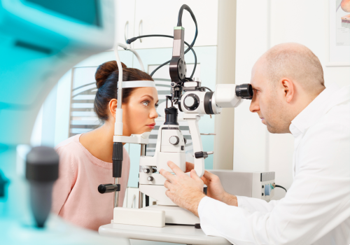 An optometrist performing an eye exam on a patient at the UC Health Hub.