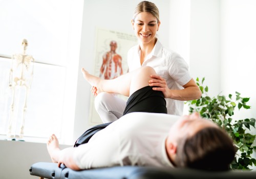 A woman help a man with leg stretches as part of Physiotherapy at UC Health Clinics