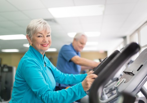 A senior woman using a treadmill and smiling at the Physiotherapy Parkinsons CLinic in the UC Health Hub.