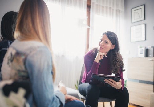 A psychologist listening intently to a patient at the UC Health Clinics.
