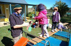 wiradjuri staff member supervising kids in outdoor area